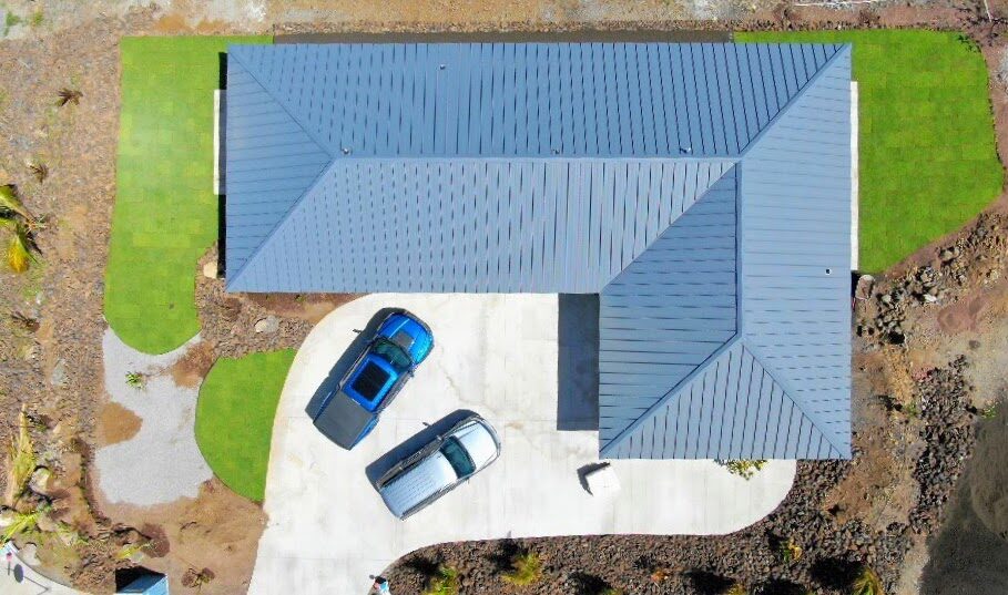 Aerial top-down view of home with blue metal roof