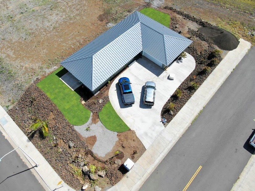 Aerial side view of home with blue metal roof